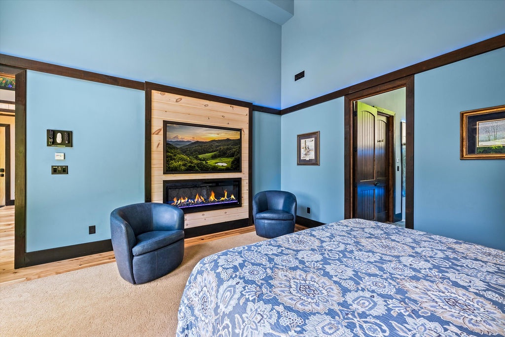 Unwind in your private retreat with calming blue tones, a cozy fireplace, and plush seating—perfect for relaxing after a day of mountain adventures.