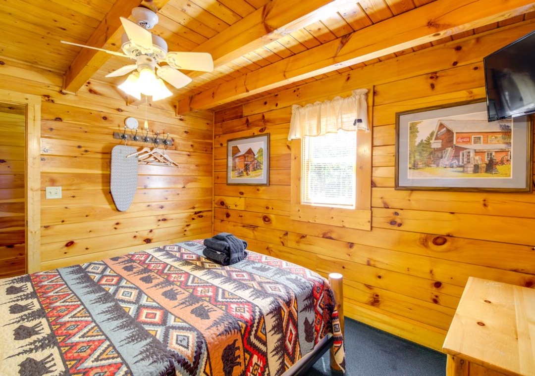 Cozy up in this charming log cabin bedroom where rustic pine walls and exposed beams create your perfect mountain retreat.