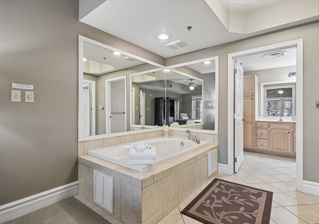 Luxurious master bathroom with soaking tub, dual vanities, and elegant finishes for your perfect spa retreat.