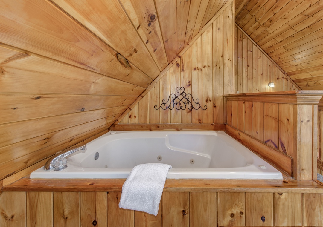 Soak away your worries in this cozy loft jacuzzi, surrounded by warm knotty pine that creates your perfect rustic retreat.