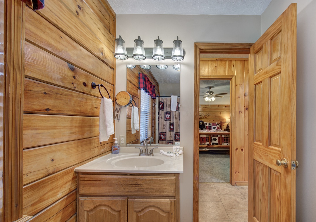 Freshen up in your rustic bathroom with warm wood accents and charming vanity lighting.