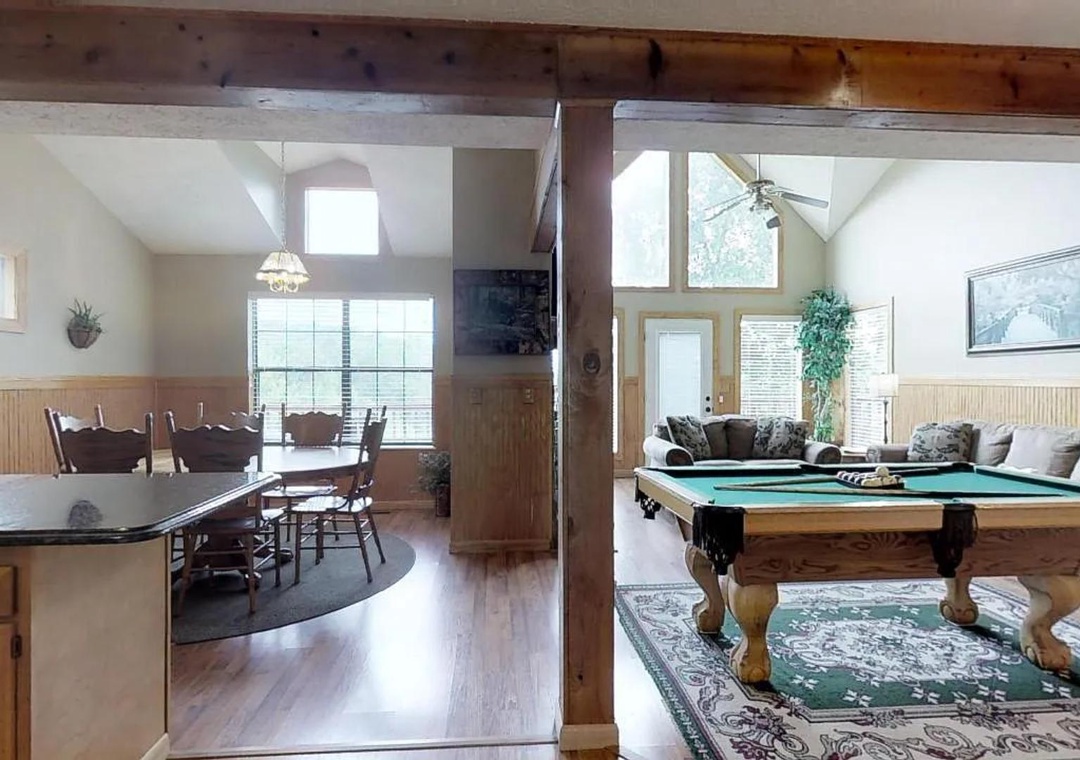 Gather with your group in this spacious open-plan retreat, where vaulted ceilings, exposed beams, and abundant natural light create a warm, inviting atmosphere perfect for meals, games, and relaxation.