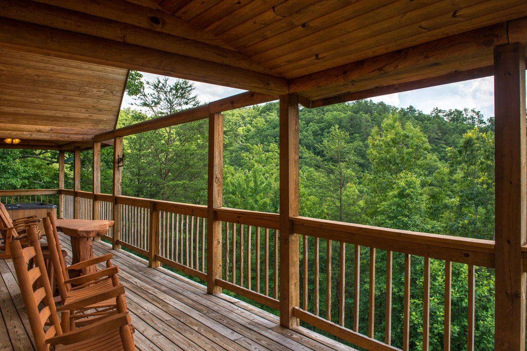 Step onto your private covered deck, settle into the wooden rockers, and let the lush mountain forest fill your view—this is where your mornings will begin and your evenings will unwind.