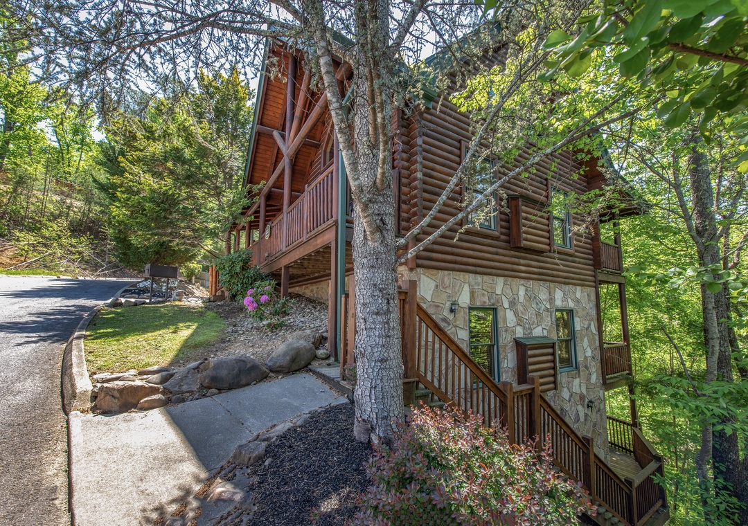 Charming log cabin nestled among towering trees, featuring natural stone accents and wooden balconies in a peaceful forest setting.