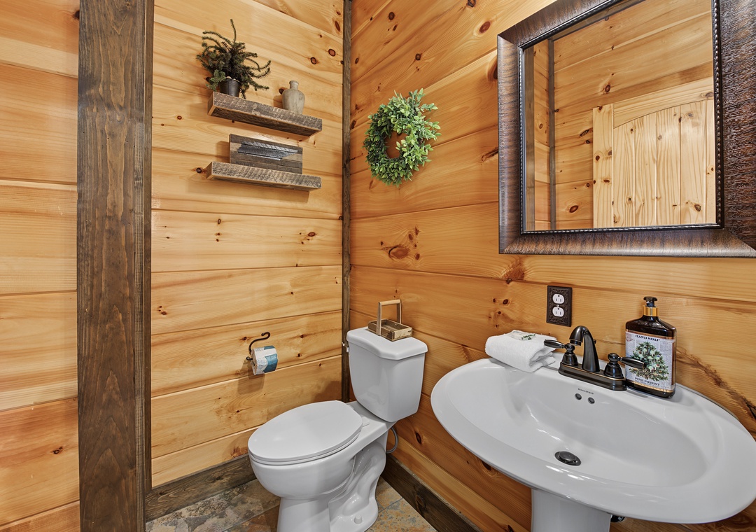 Unwind in this cozy cabin-style bathroom, where warm pine walls and rustic touches create a peaceful retreat for refreshing during your mountain getaway.