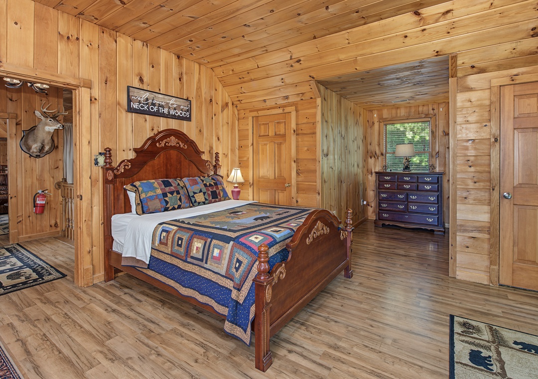 Drift off in your rustic cabin retreat, where warm wood envelops you and a handcrafted bed invites restful nights under exposed timber ceilings.
