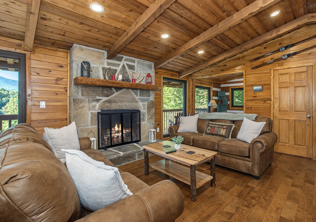 Sink into plush sofas by the stone fireplace and enjoy mountain views through your windows—your perfect retreat awaits.