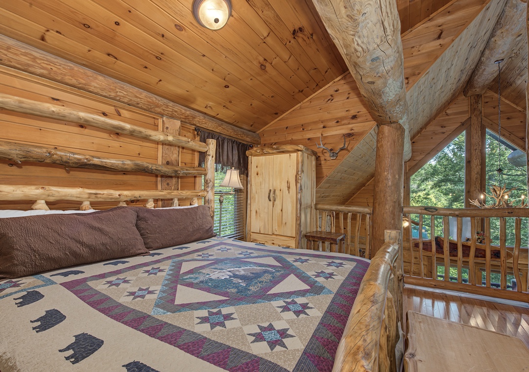 Wake up surrounded by natural wood beams and rustic charm, with a lofted ceiling that draws your eyes upward. Your balcony overlooks lush greenery, inviting you to step outside and breathe in the mountain air.