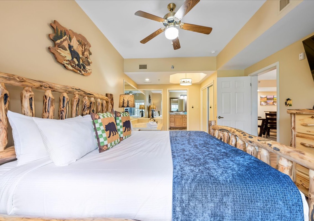 Cozy rustic bedroom with handcrafted log furniture, crisp linens, and woodland décor creates your perfect mountain retreat sanctuary.