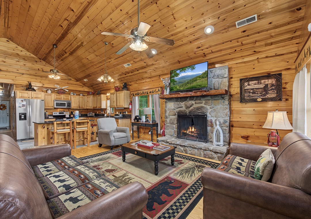 Gather around the stone fireplace in this warm, open-plan cabin retreat. Vaulted wood ceilings, a fully-equipped kitchen, and cozy leather seating invite relaxation after a day exploring the mountains.
