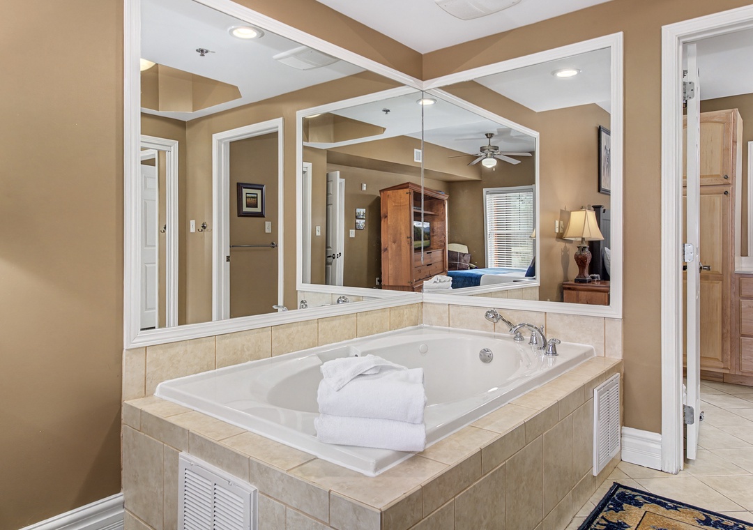 Unwind in your private soaking tub with soft towels and elegant tile surroundings for the ultimate relaxation.