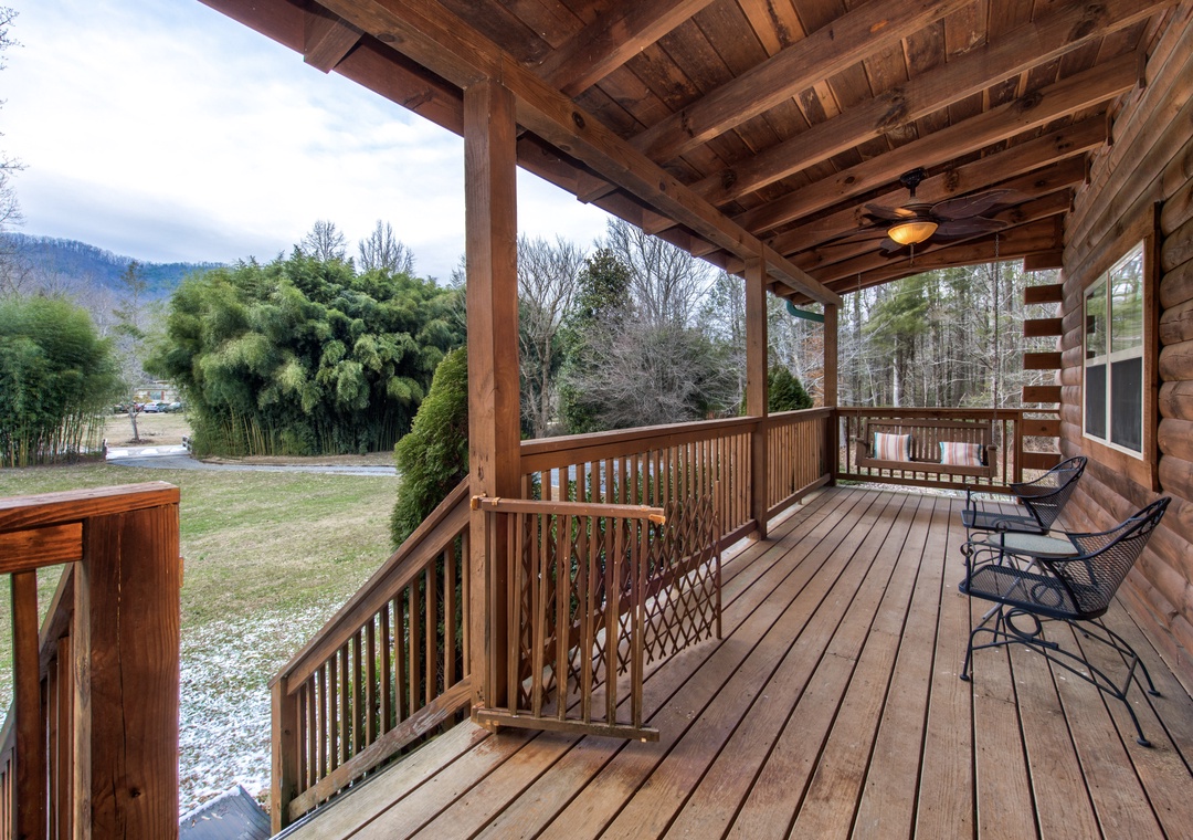 Your private deck offers sweeping views of rolling hills and lush forests, perfect for morning coffee or evening relaxation in comfortable outdoor seating.