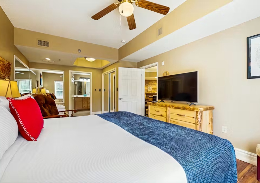 Drift off to sleep in your rustic-chic bedroom, complete with charming ceiling fan and entertainment center for cozy evenings.