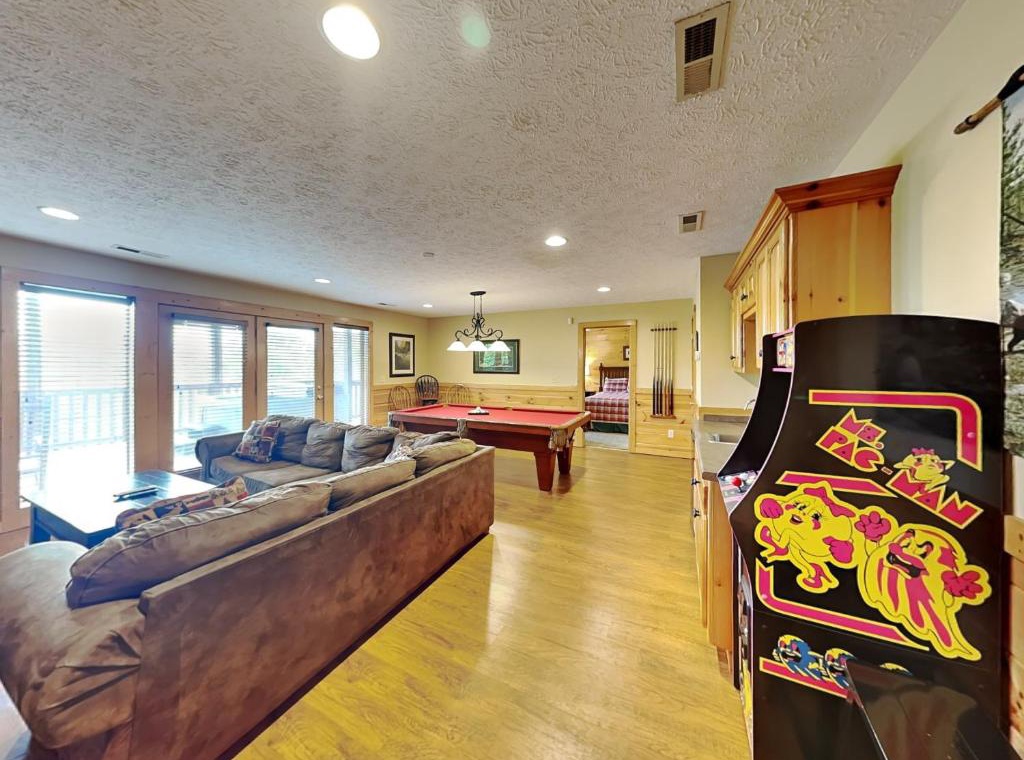 Your entertainment haven awaits with vintage arcade games, pool table, and plush seating - perfect for memorable evenings with family and friends.