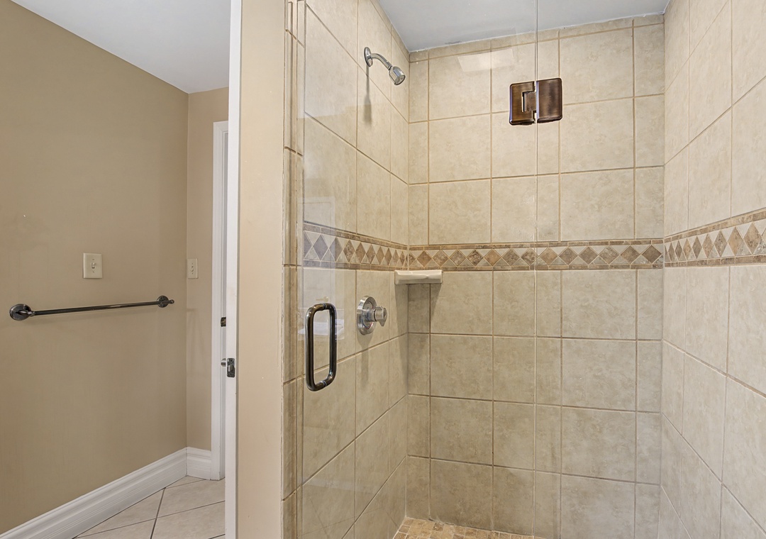 Step into your private sanctuary with this spacious walk-in shower featuring elegant tile work and glass enclosure for a luxurious bathing experience.