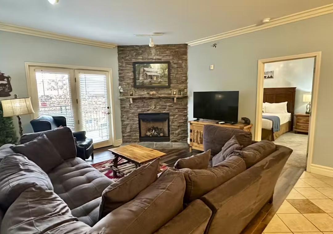 Sink into plush leather sofas by your stone fireplace, where warm evenings begin with the TV or a good book in this inviting living space.