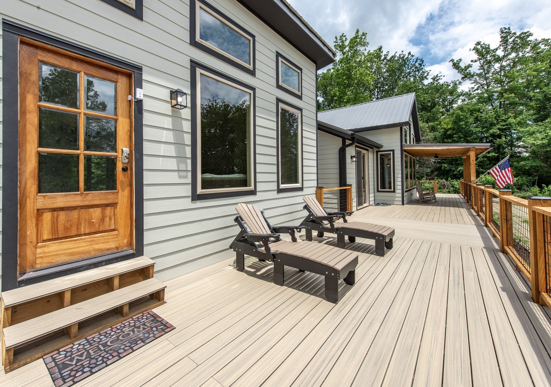 Stretch out on your private deck with lounge chairs surrounded by lush greenery. This peaceful outdoor space invites you to relax, soak up the sun, and breathe in the fresh mountain air.