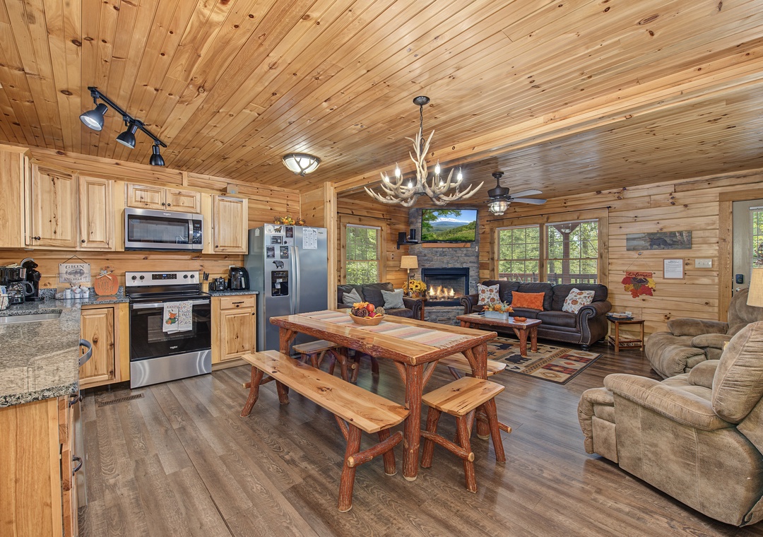 Relax in your inviting open-concept cabin where rustic wood beams and a cozy fireplace create the perfect mountain retreat atmosphere. Gather around the handcrafted dining table or unwind in the spacious living area after exploring nearby trails.