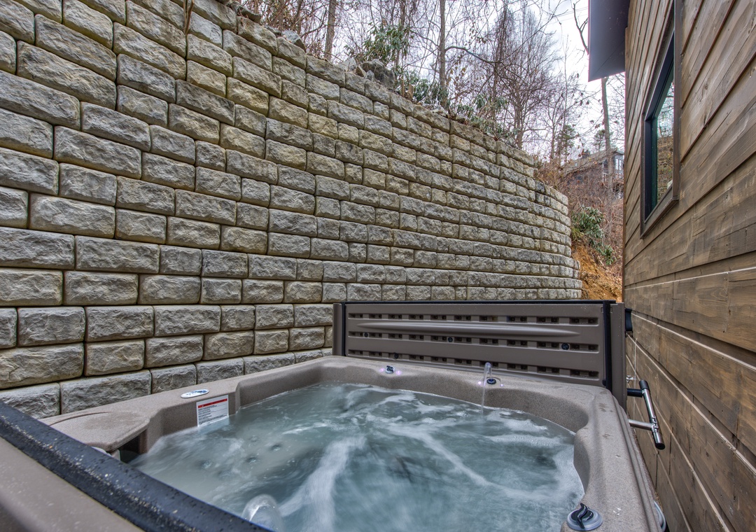 Slip into your private hot tub sanctuary, where warm bubbling waters soothe your muscles against a backdrop of natural stone.
