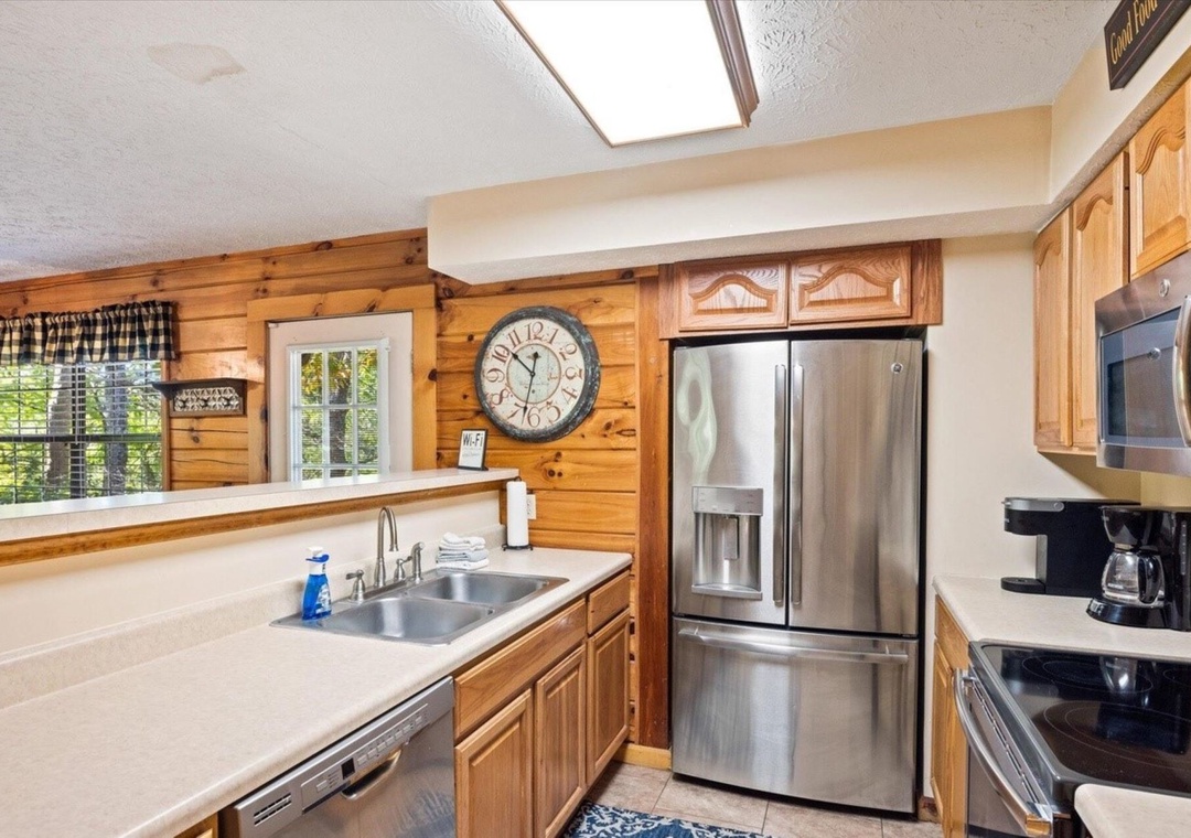 Cook in your rustic cabin kitchen with stainless appliances, warm wood accents, and skylight brightening your culinary adventures.