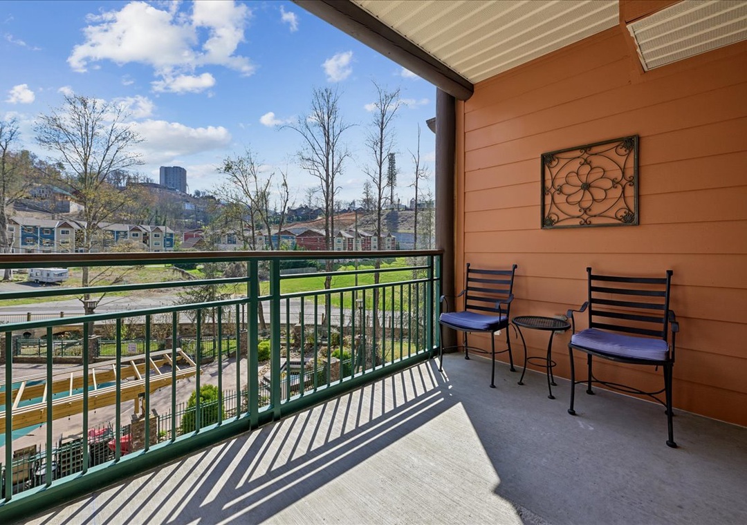 Enjoy morning coffee on your private balcony, where comfortable seating and stunning city views create the perfect retreat.