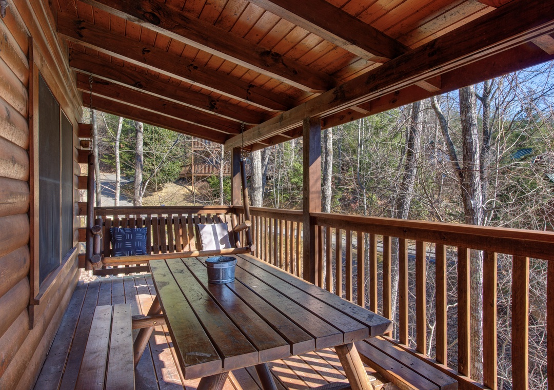 Your private balcony offers rustic charm with exposed beams and forest views, perfect for morning coffee or quiet evenings outdoors.