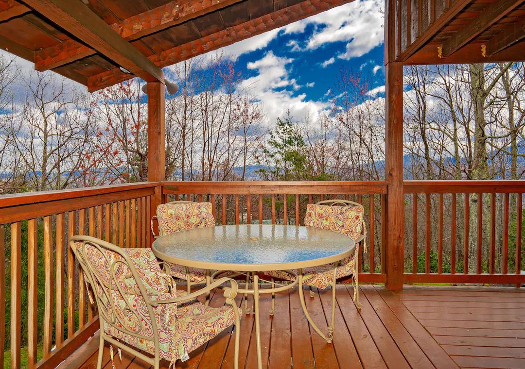 Your private mountain deck invites peaceful mornings with coffee while soaking in stunning forest views and endless blue skies.