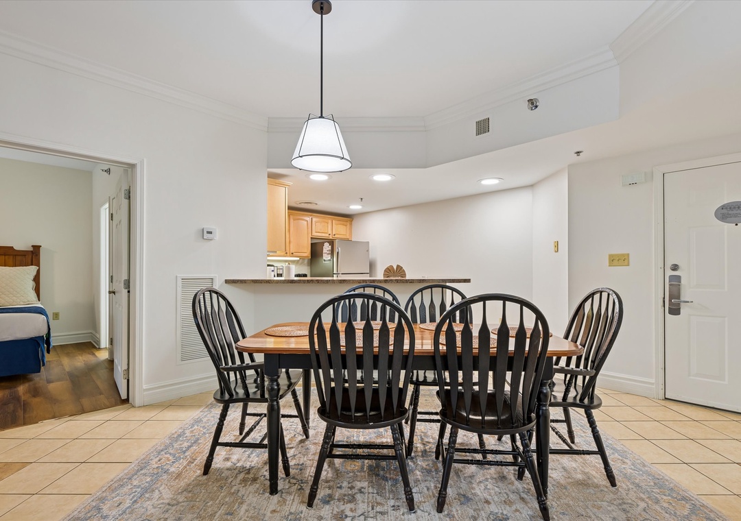 Gather around this charming dining table where your group can share memorable meals together in this bright, open space.