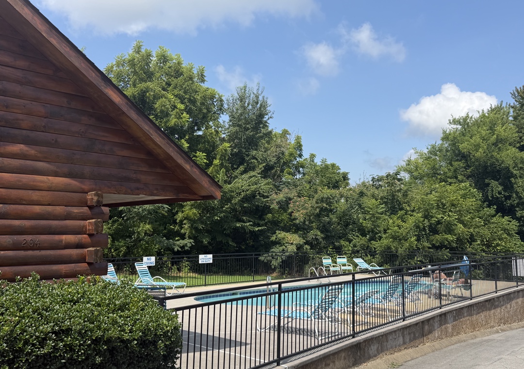 Surrounded by lush greenery, the outdoor pool offers a peaceful retreat on warm summer days, with plenty of lounge chairs for soaking up the sun.