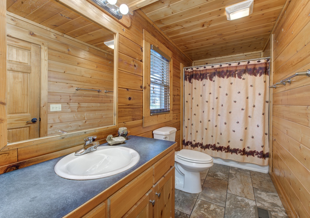 Step into your private cabin bathroom, where rustic pine walls and thoughtful amenities create a cozy retreat after your mountain adventures.