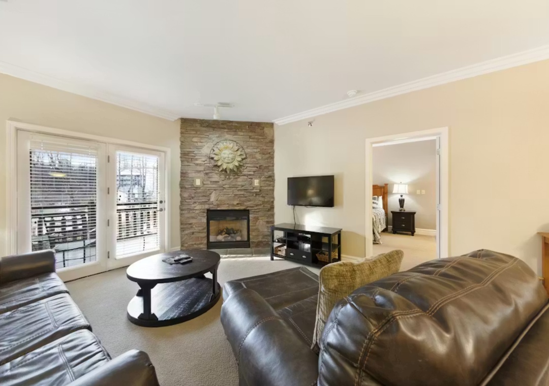 Relax in your spacious living room with cozy leather seating, stone fireplace, and flat-screen TV for perfect evenings in.