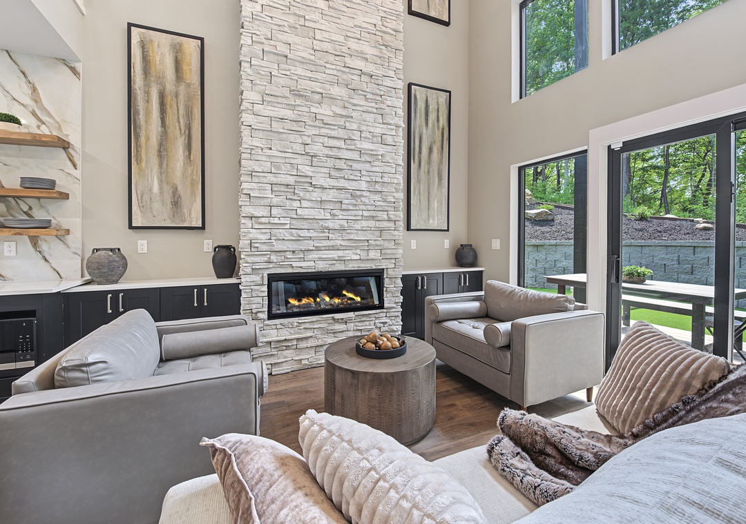 Sink into plush seating and watch the flames dance in your elegant stone fireplace, or open the doors and step onto your private patio surrounded by lush greenery.