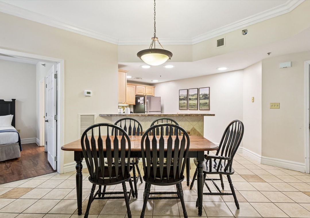 Gather around your spacious dining table where memorable meals and conversations flow naturally. The open layout connects you to the kitchen for easy entertaining.
