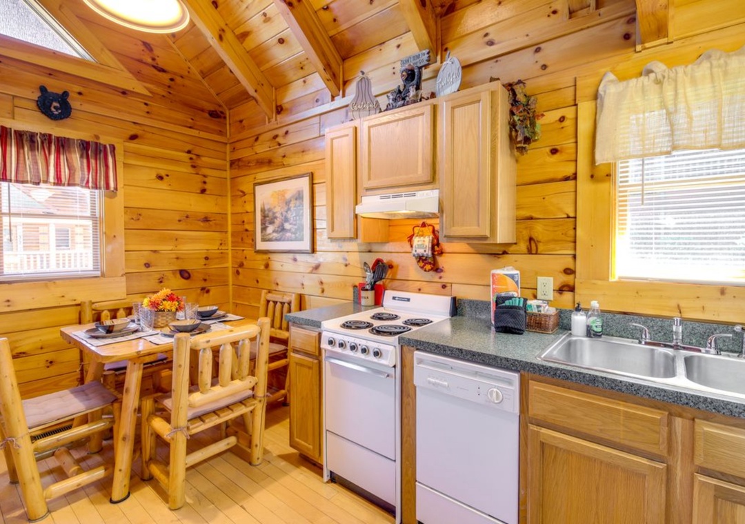 Your rustic log cabin kitchen combines cozy charm with modern convenience, featuring warm wood throughout and everything you need for memorable meals.