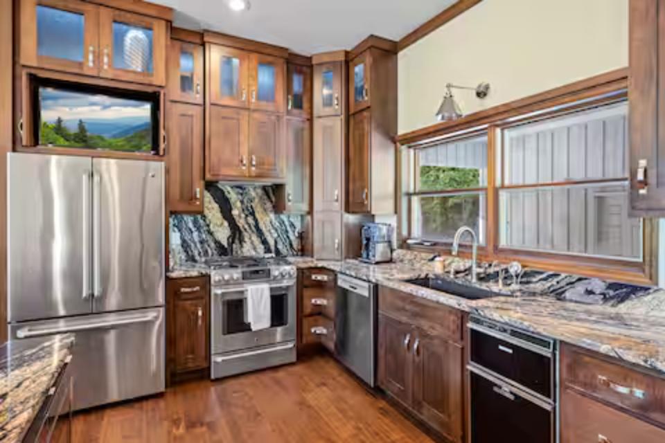Your gourmet kitchen features rich wood cabinetry, granite counters, and premium stainless steel appliances for memorable home-cooked meals.