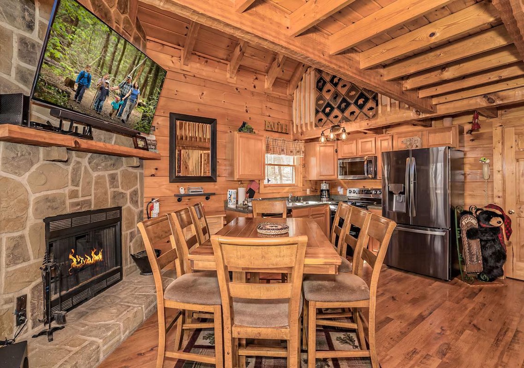 Gather around your cozy cabin kitchen where rustic wood beams frame memorable meals by the crackling stone fireplace.