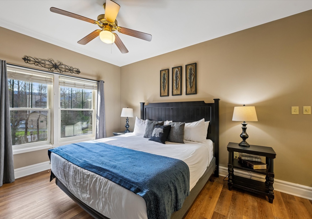 Sink into crisp white linens beneath your gentle ceiling fan, with morning light streaming through oversized windows.