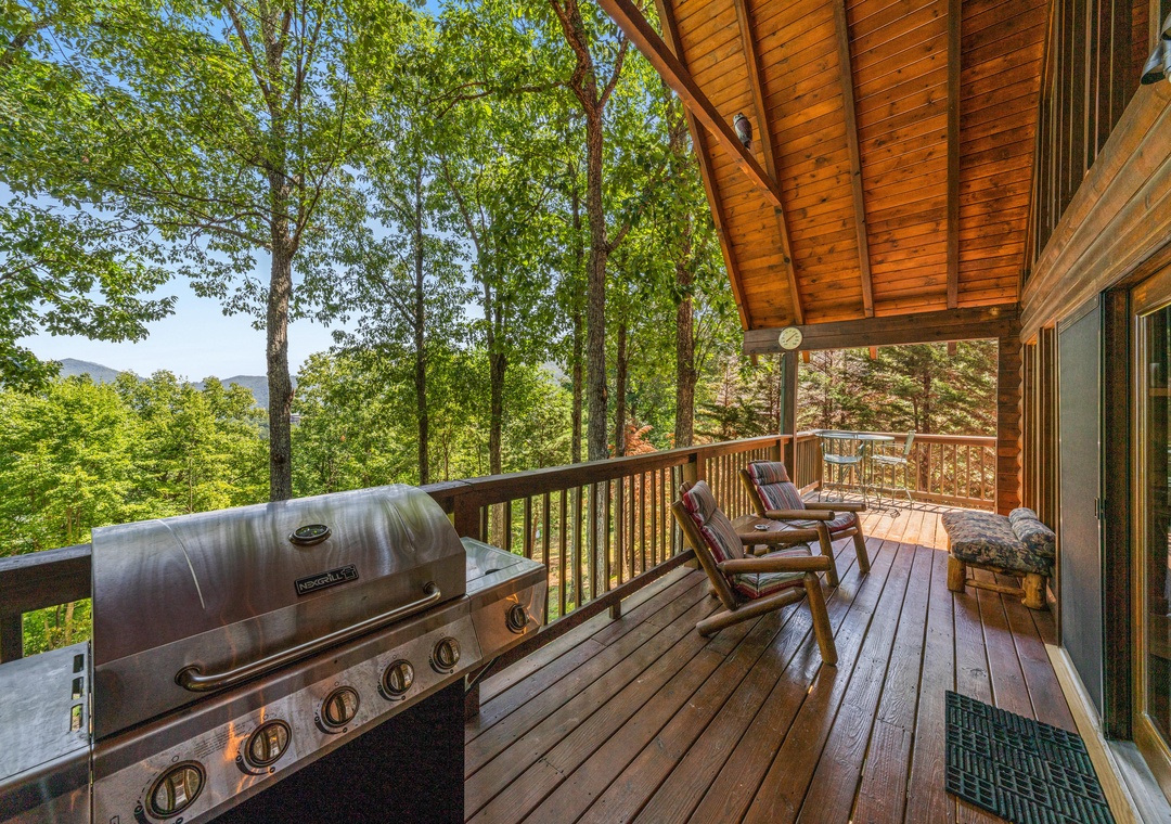 Picture yourself relaxing in the rocking chairs on this stunning deck, surrounded by lush mountain forest. Grill your favorite meals while soaking in peaceful tree-lined views and fresh air under a beautiful wood-beamed overhang.