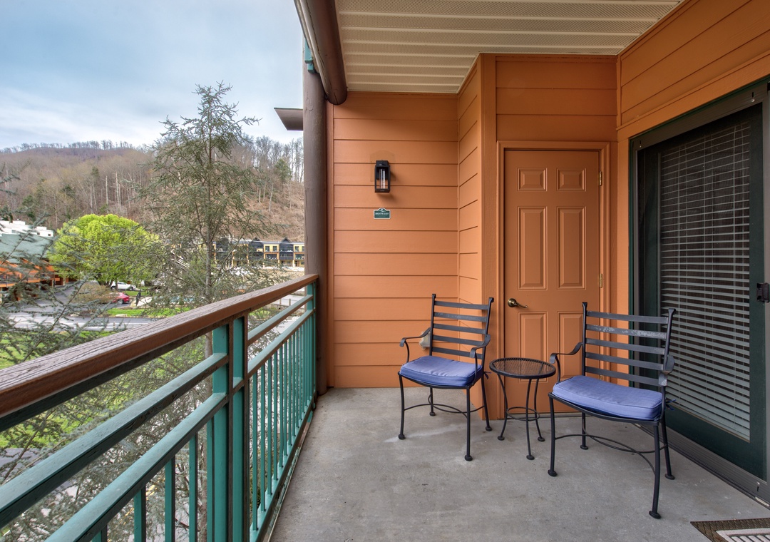 Unwind on your private balcony with mountain views, perfect for morning coffee or evening relaxation in comfortable seating.