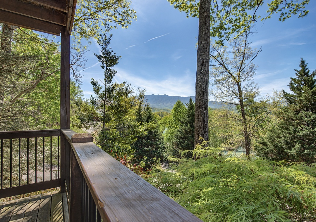 Step onto your private balcony where mountain vistas and forest canopy create the perfect backdrop for morning coffee or evening relaxation.