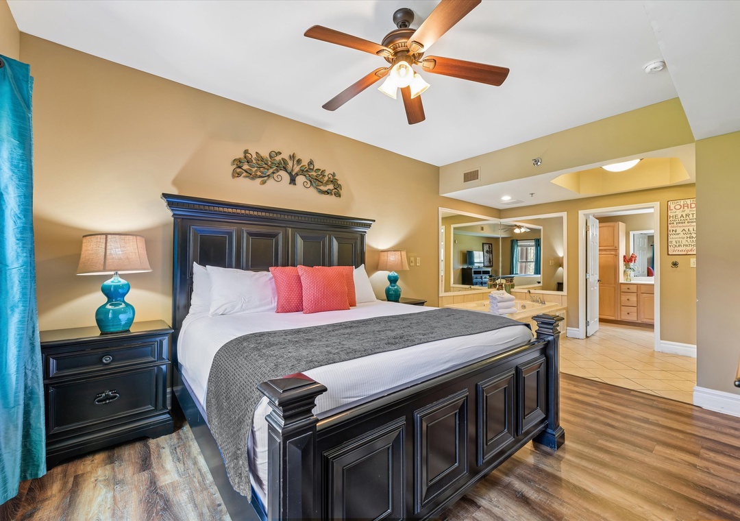 Unwind in your elegant bedroom featuring a luxurious king bed, rich wood furnishings, and thoughtful touches that create the perfect retreat.