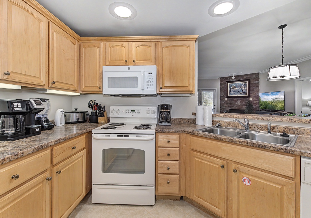 Your fully-equipped kitchen features warm wood cabinets and granite counters, perfect for preparing memorable meals during your stay.