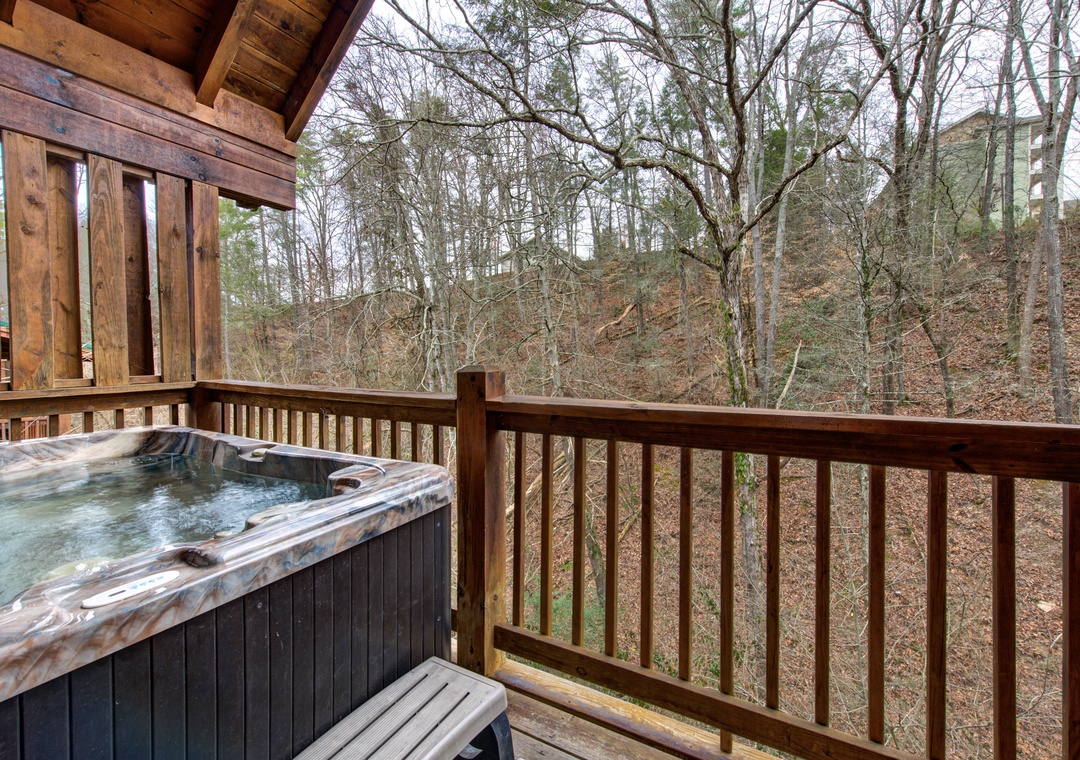 Soak away your stress in your private hot tub while enjoying peaceful wooded views from your secluded deck.