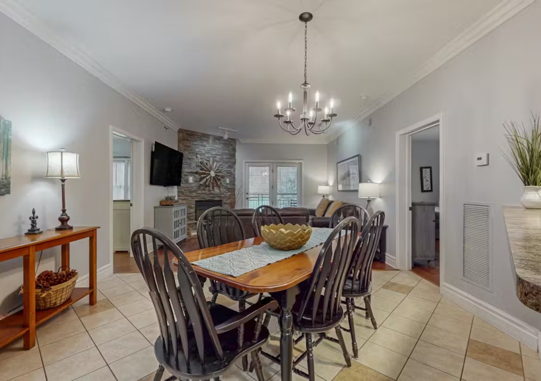 You'll love gathering around this inviting dining table, where the elegant chandelier creates perfect ambiance for memorable meals together.