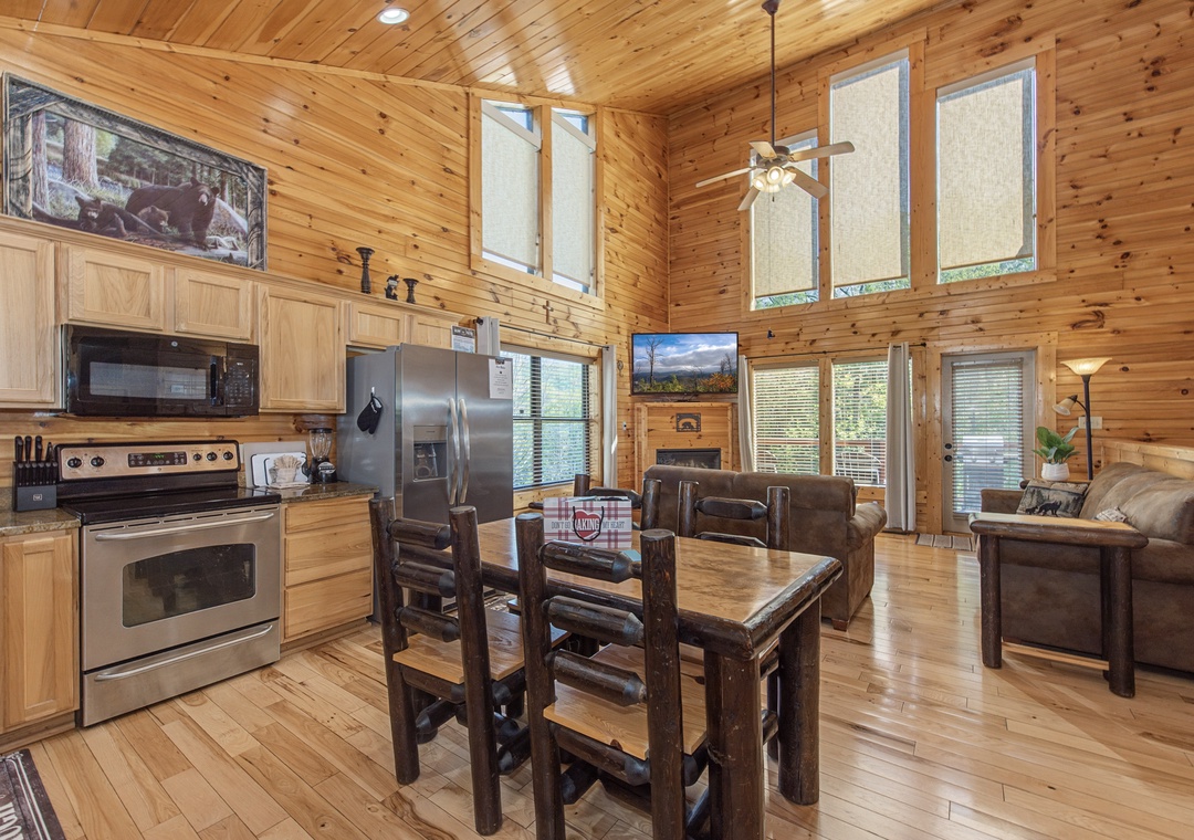 Relax in your open-concept cabin with warm wood accents, fully equipped kitchen, and cozy dining space perfect for mountain meals.