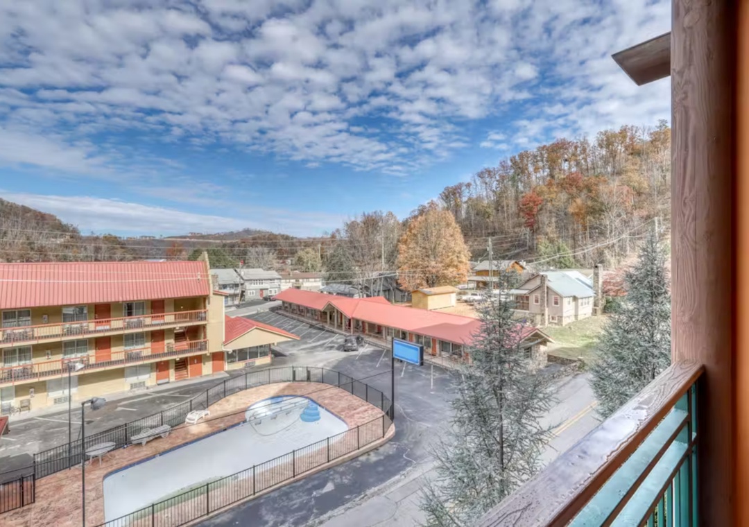 Autumn mountain views and resort amenities spread below your private balcony overlook.