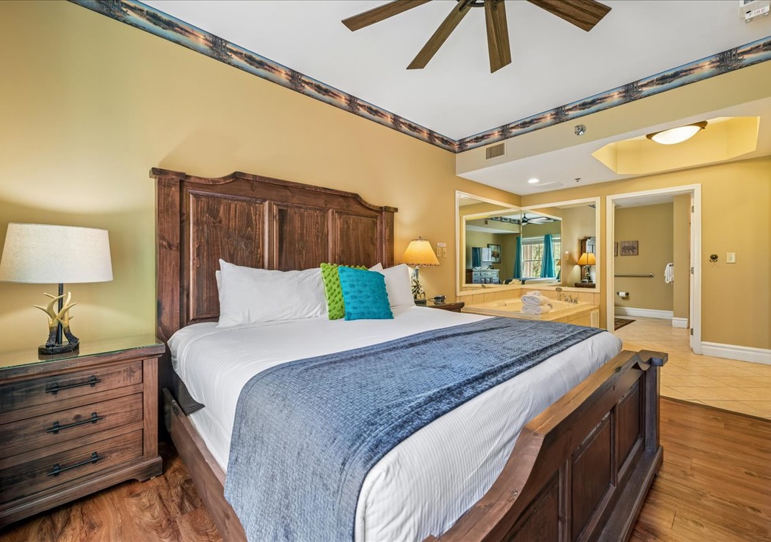 Unwind in your spacious master suite featuring rustic wood furnishings, plush bedding, and an elegant en-suite with soaking tub for ultimate relaxation.