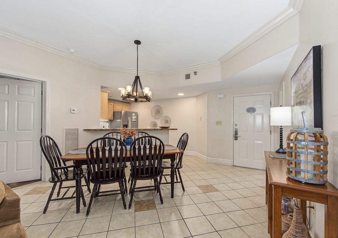Gather around your elegant dining table for memorable meals in this bright, open space featuring warm wood furnishings and charming coastal décor.