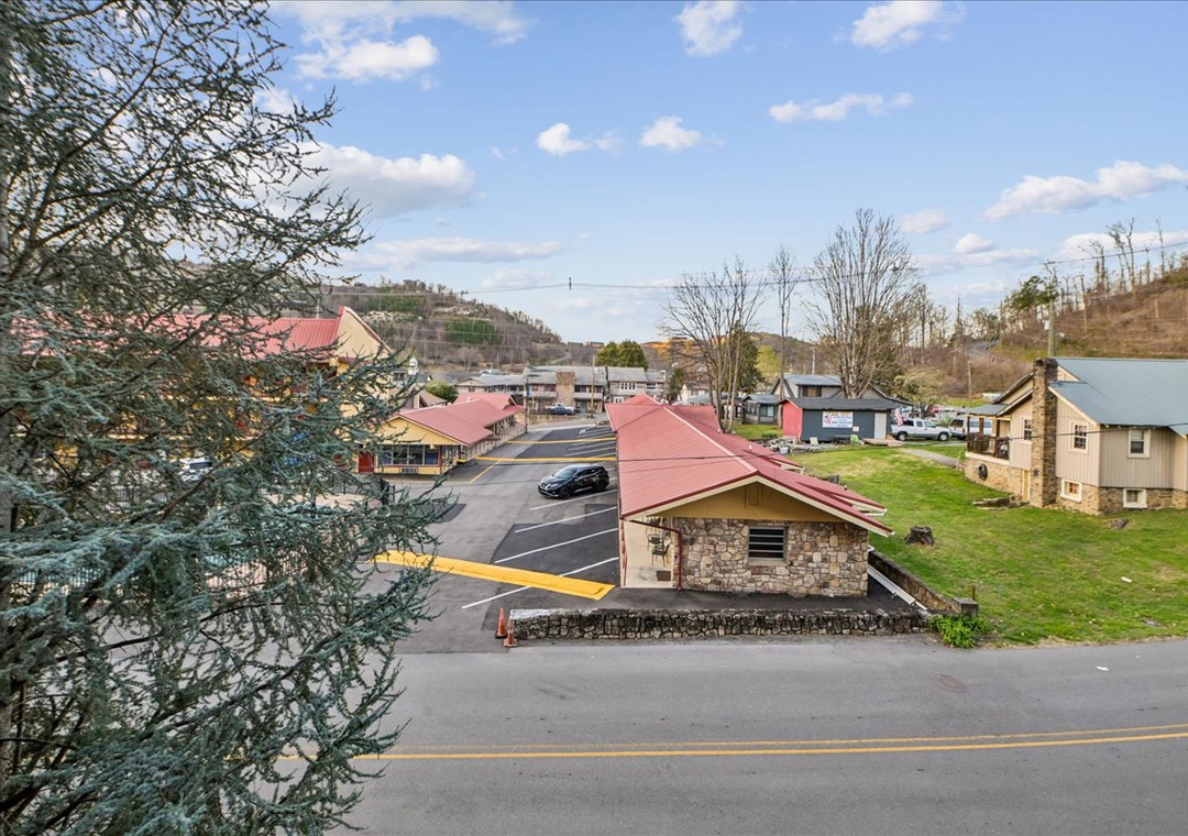 A charming mountain town setting with stone buildings, rolling hills, and peaceful residential streets creating a picturesque getaway destination.