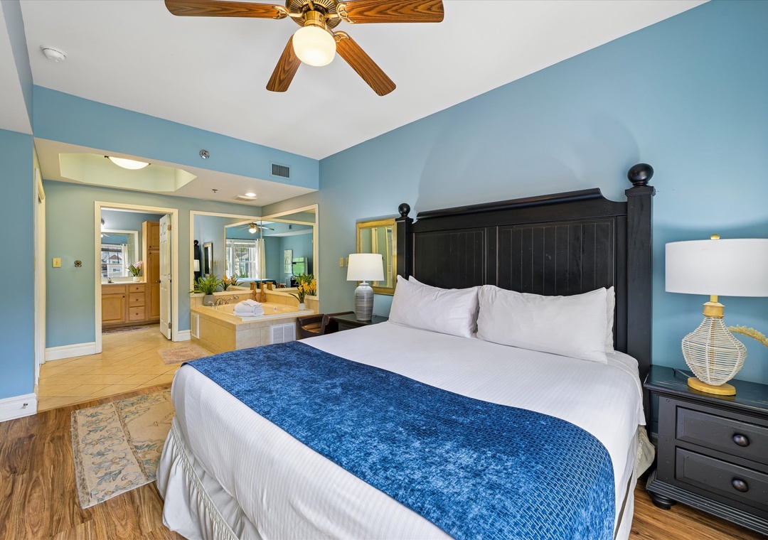 Your coastal-inspired bedroom features a plush king bed and stunning spa tub, creating your perfect romantic retreat.